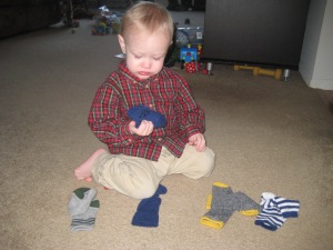 He likes to take all the socks out of his drawer, pull apart the pairs, and bring them into the living room, so I turned it into a matching game. Too easy Mama!