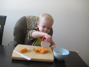 Intro to chopping: plastic tools and soft melon. Most of the melon got "chopped" with his teeth. Yum!