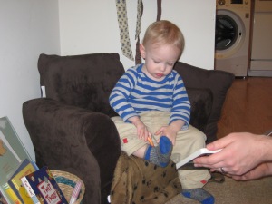 Sitting on his new chair, reading with Daddy.