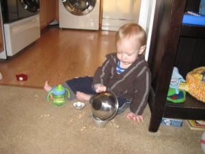Having a snack and keeping busy while Mommy makes dinner. See that mess?  Perfect opportunity to test the carpet sweeper! 
