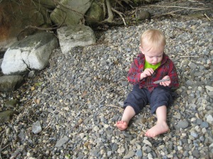 Sitting on a pebbly bit of shore, coloring on rocks with a piece or charcoal we found.