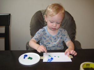 He told me he wanted green and blue paint, and that he was going to paint with a tooth pick. Awesome! 