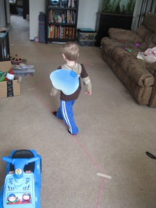 Immediately following clean-up of the paper disaster, Lewis told me he needed a squiggly line path on the carpet going all the way to the other room. We usually use washi tape or masking tape for this, but discovered that yarn actually works very well and can more easily reach long distances through the house. He had fun driving his car, running, and chasing Mommy and Daddy on his zig-zag path. 
