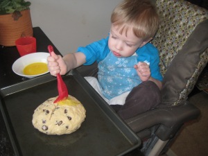 Painting the egg wash onto our Irish Soda Bread this morning.