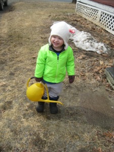 Wearing a hat we discovered in the house, and using a watering can to water all the snow because it was "thirsty."