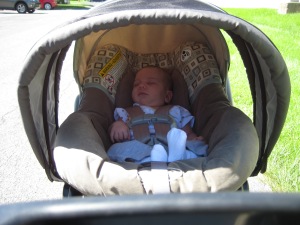 Baby girl sleeping in the stroller.